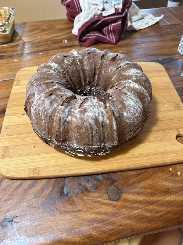 Lino Cantú’s bundt cake dusted with powdered sugar on a wooden board