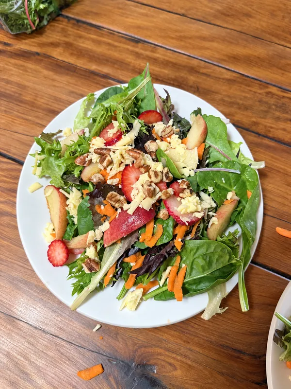 Lino Cantú’s salad with leafy greens, berries, avocado, cheese and nuts